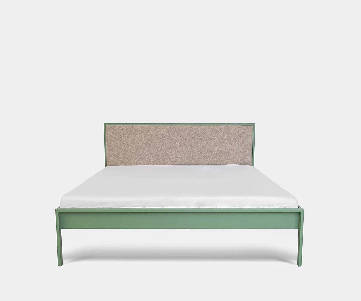 Green metal bed with beige upholstered headboard – front view Modern green metal bed with beige upholstered headboard without footboard, front view